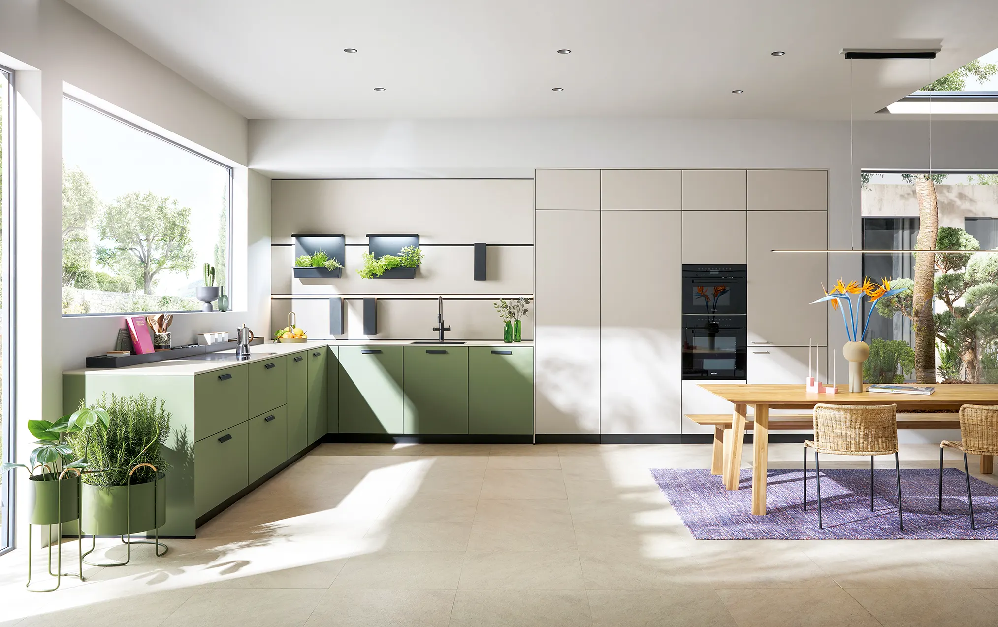 Sage green and cream kitchen opening onto a dining area