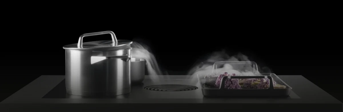 Cooking vapour drawn into a worktop extractor
