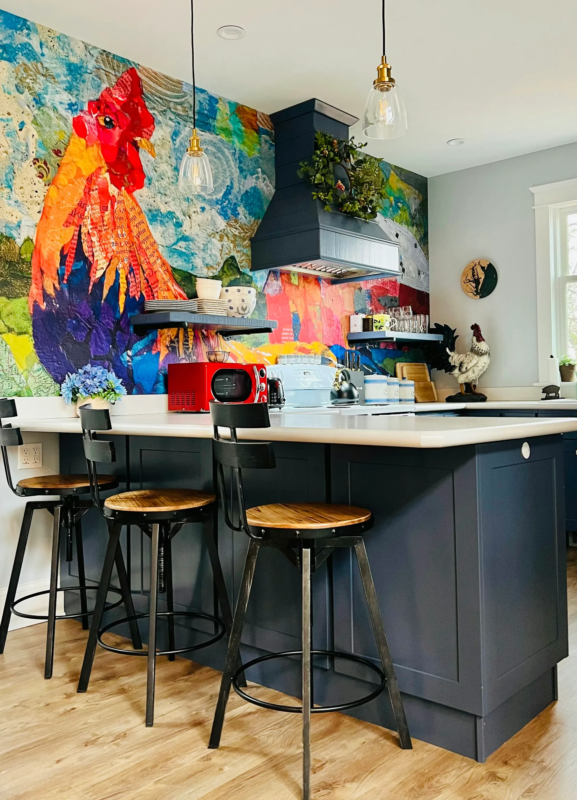 Navy kitchen island with a colourful painted splashback