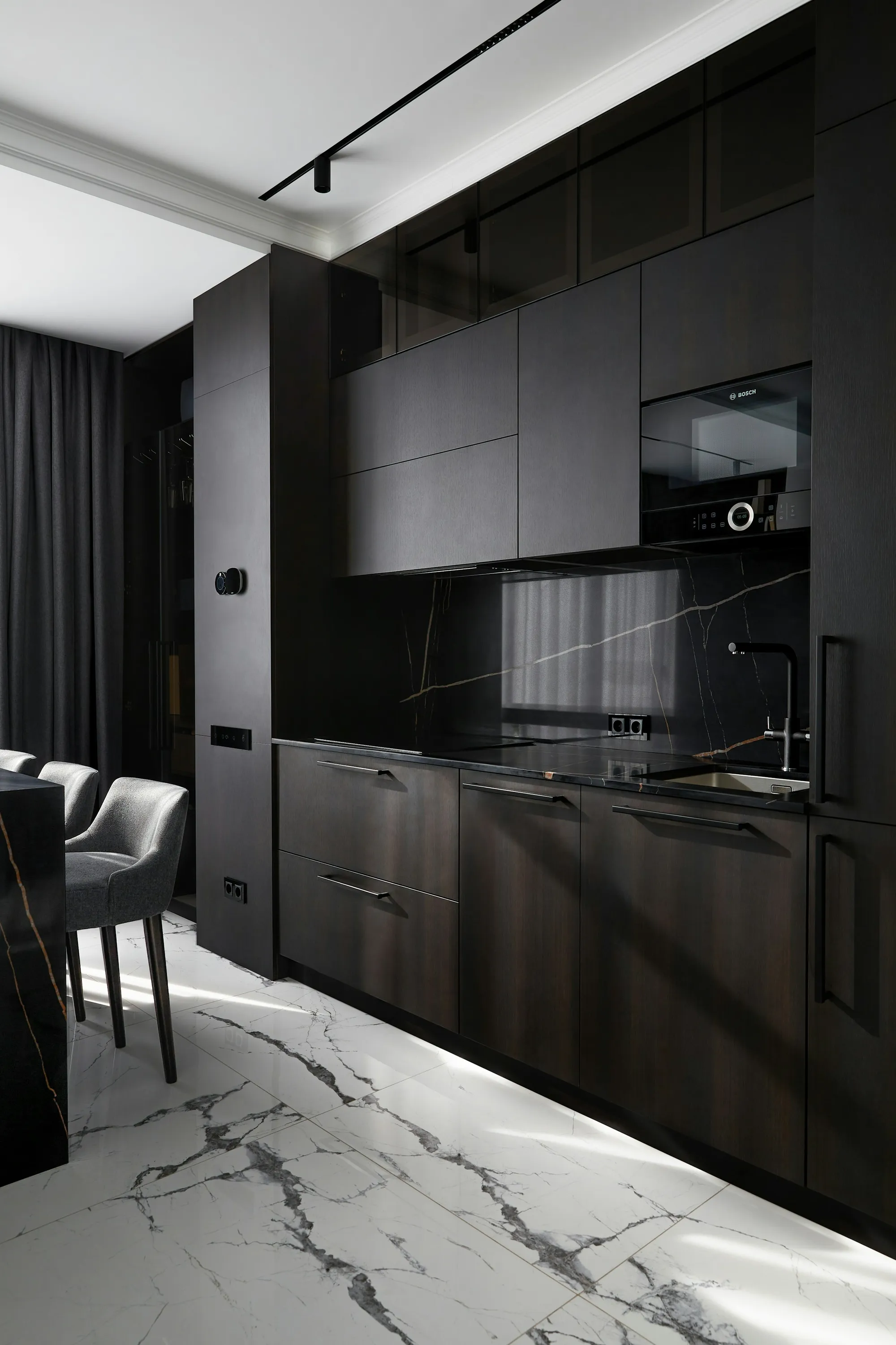 Dark timber kitchen with a black marble splashback