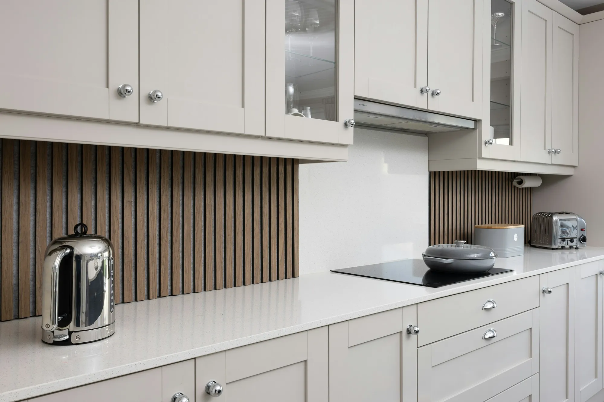 Cream shaker kitchen with a slatted timber splashback