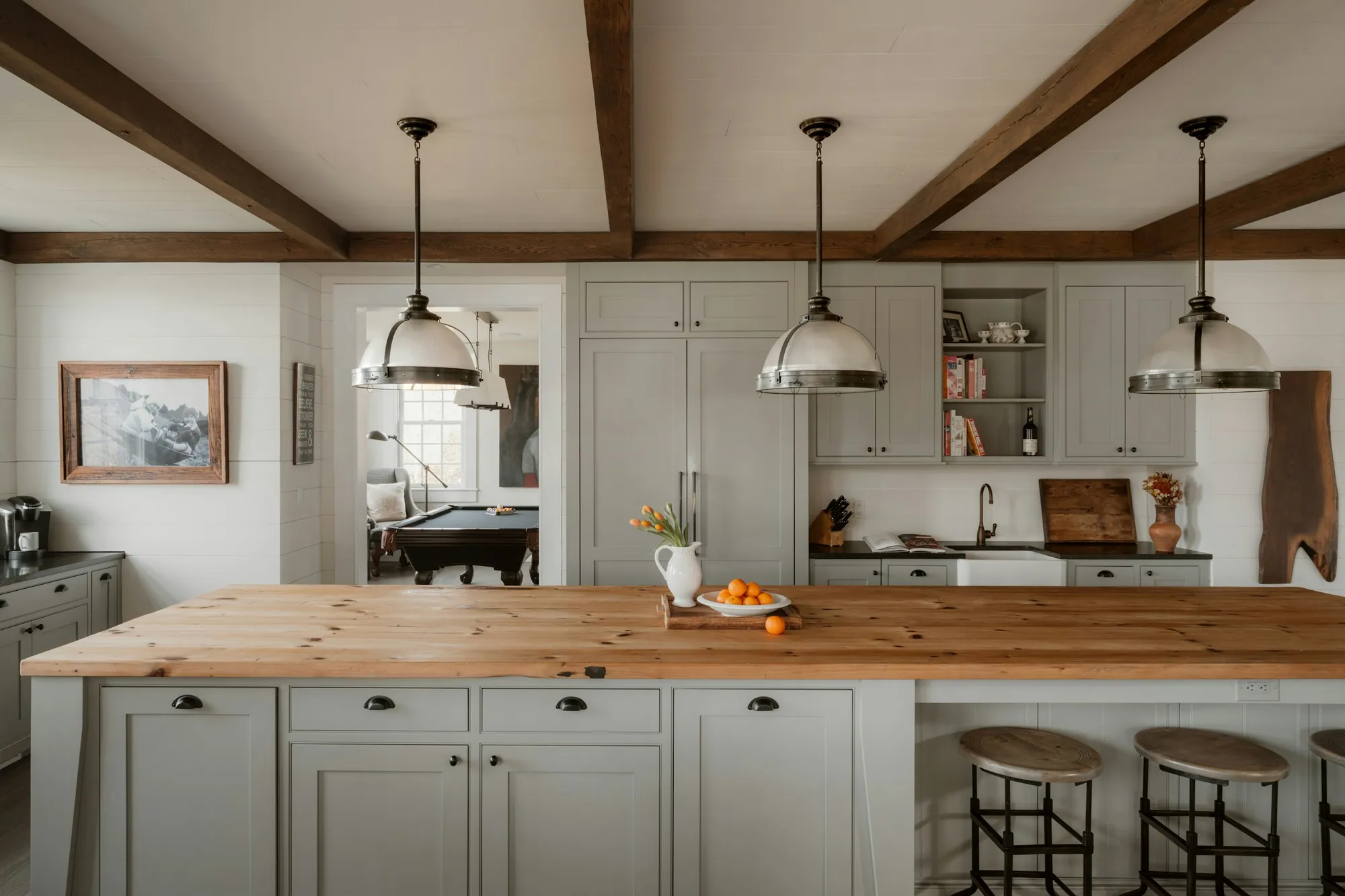 Soft grey-beige shaker kitchen with a timber island and exposed beams