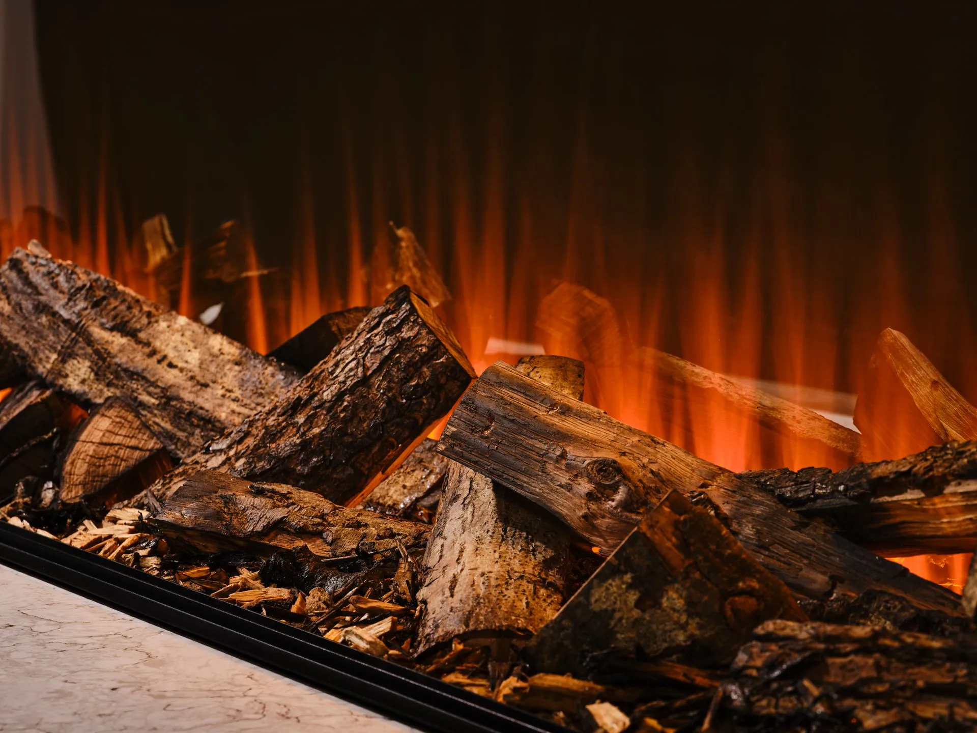Close view of handcrafted oak logs glowing in a British Fires electric fire