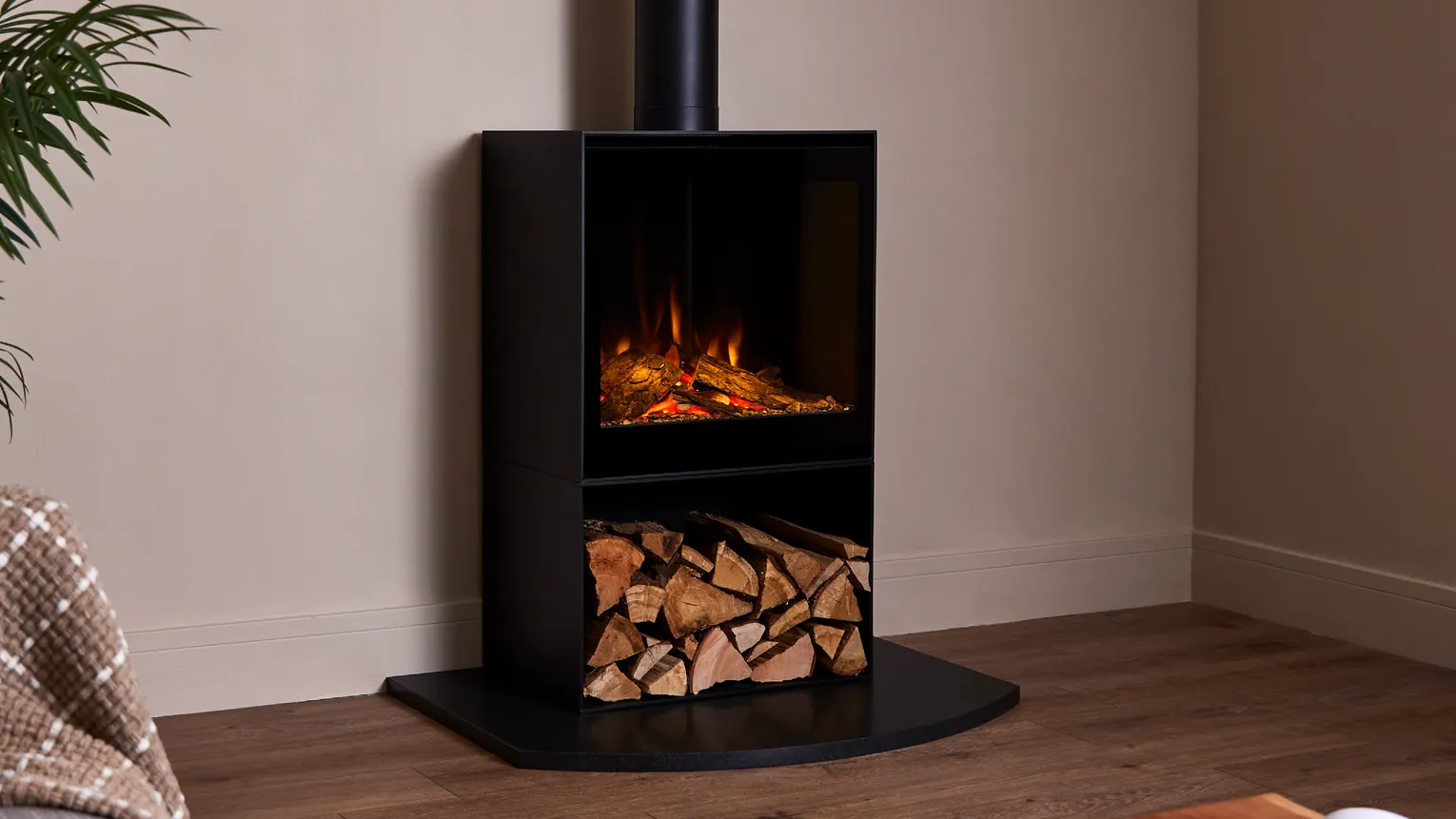 British Fires freestanding black electric stove with a log store beneath