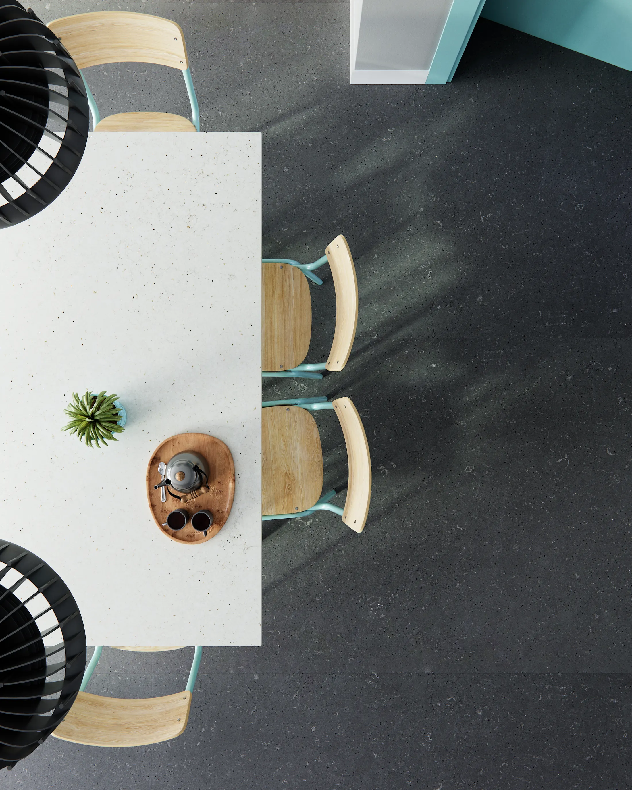 Overhead view of a pale worktop with a plant and two chairs