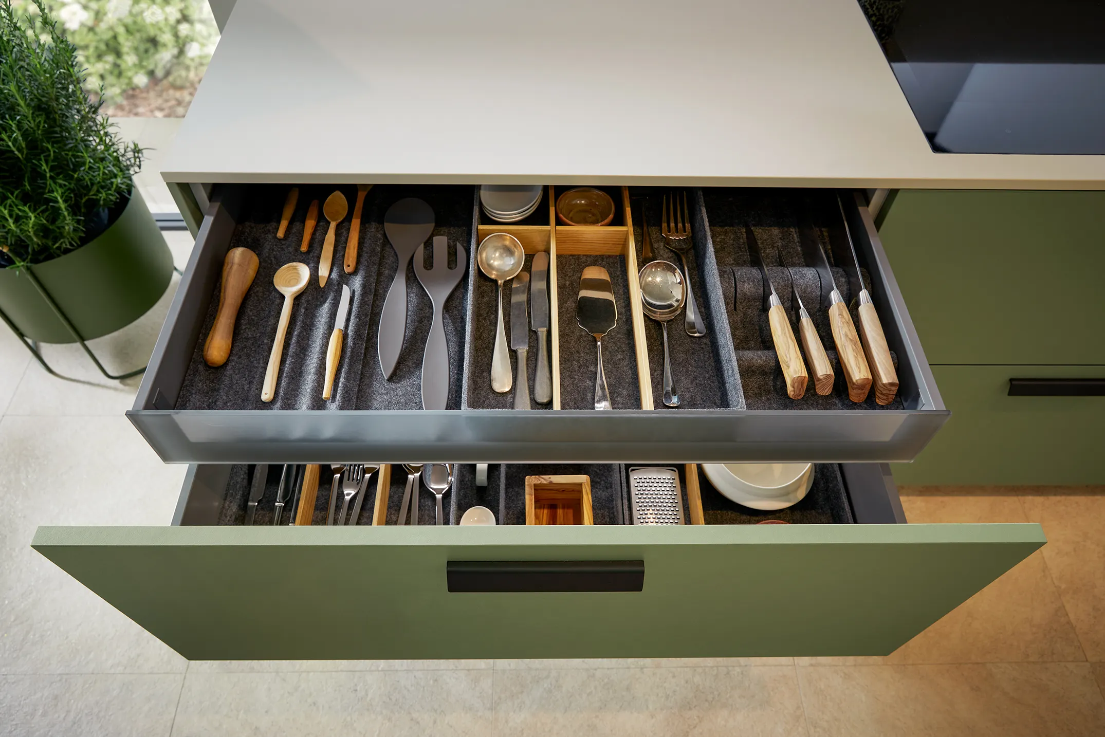 Organised cutlery drawer in a sage green kitchen