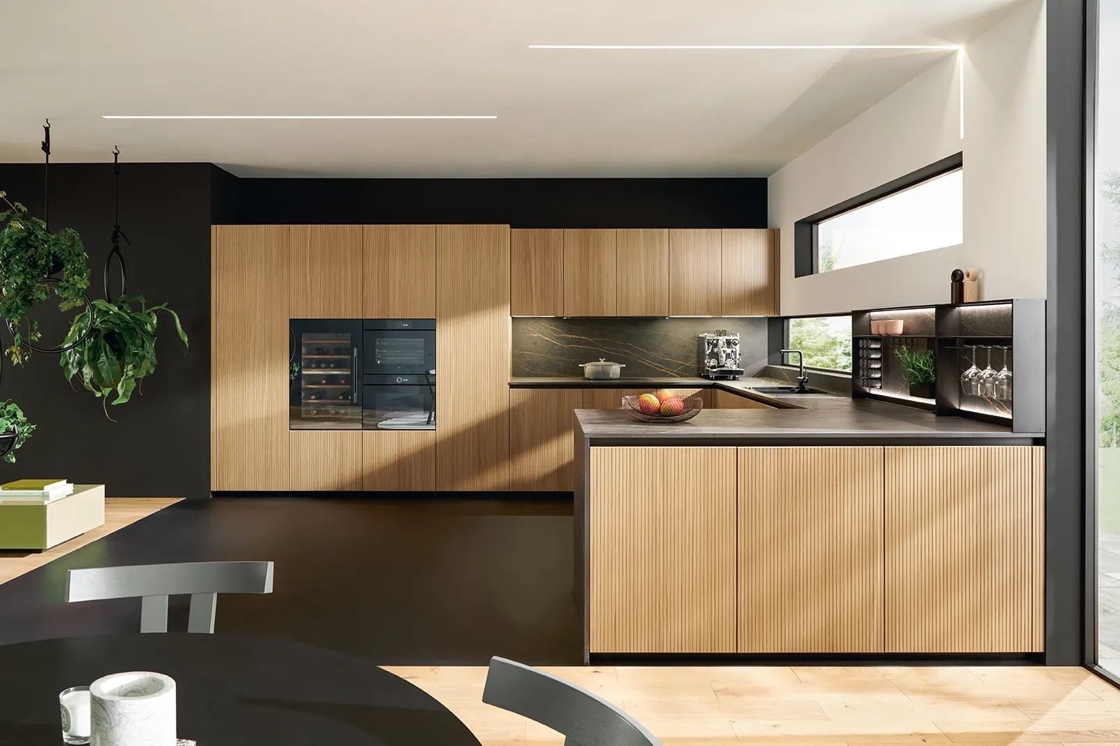 Handleless kitchen with warm timber drawers and a pale glass cabinet