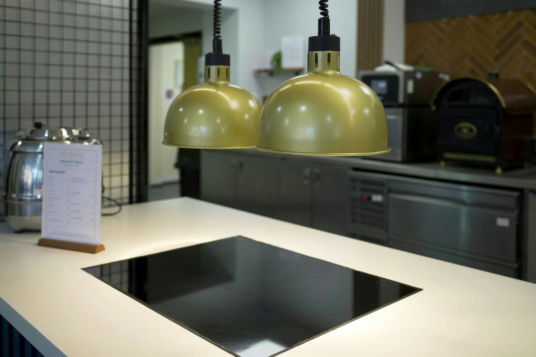 Induction hob set flush into a pale island worktop