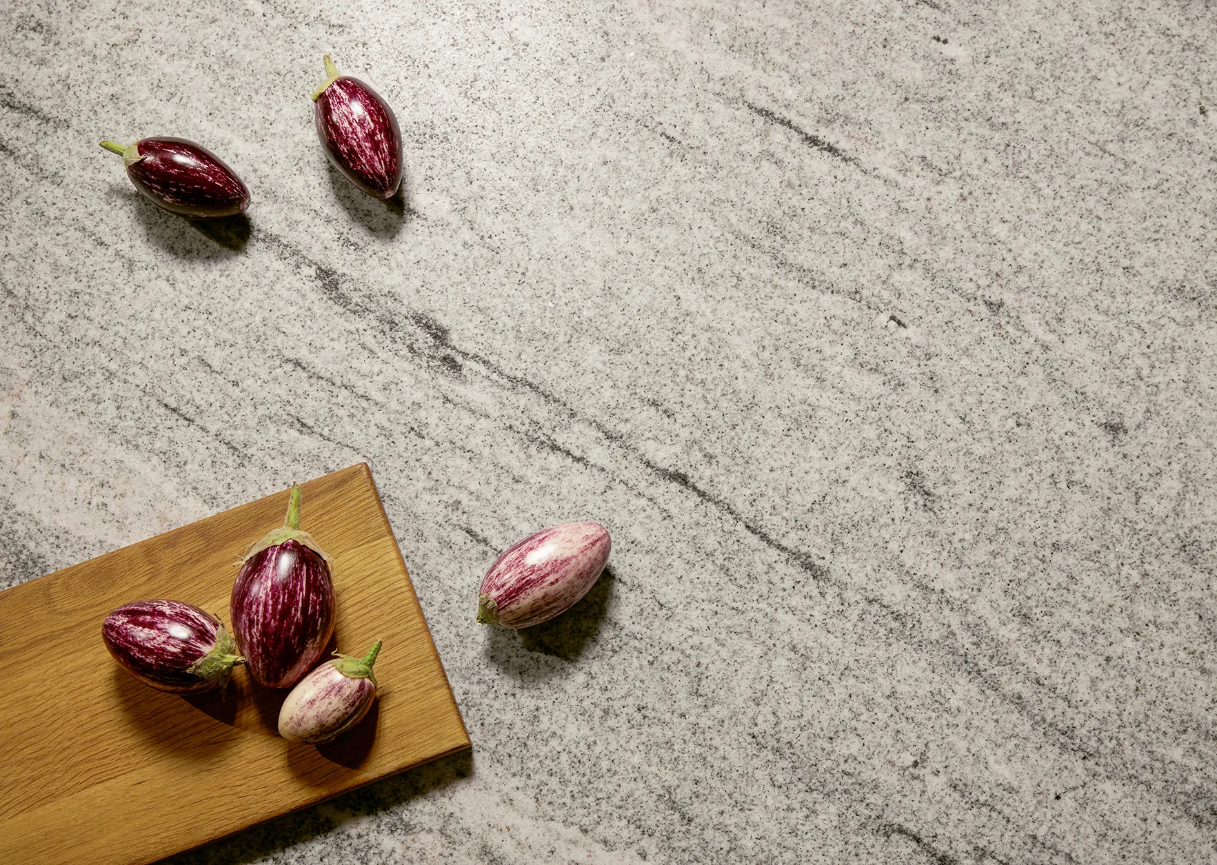 Kitchen with a white marble-effect worktop waterfall end